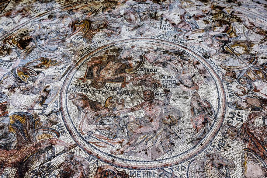 This picture taken on October 12, 2022 shows a view of a mosaic floor dating to the Roman era being excavated in the city of al-Rastan in Syria's west-central province of Homs, after its discovery was announced by Syria's General Directorate of Antiquities. - Syria revealed on October 12 a remarkably intact 1,600-year-old Roman-era mosaic including depictions of warriors in the Trojan War, with authorities hailing it as one of the "rarest" found. The mosaic is the latest to be found in Rastan, which the government seized back from rebels in 2018 after years of bloodshed. "It is not the oldest of its kind, but it's the most complete and the rarest," according to Syria's General Directorate of Museums. (Photo by Louai Beshara / AFP) (Photo by LOUAI BESHARA/AFP via Getty Images)