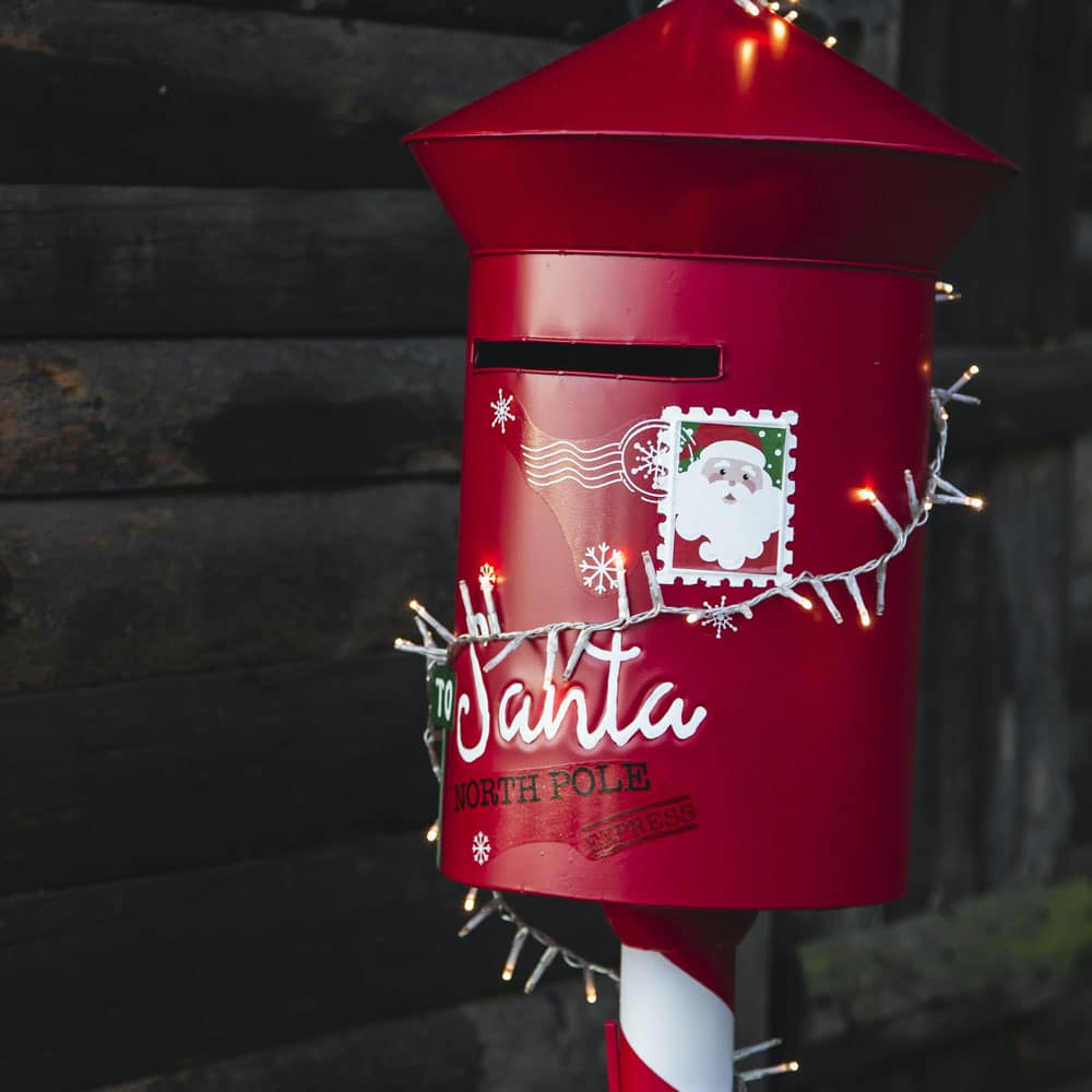 Things to do over Christmas including posting a letter to Santa. Red festive post box with Santa on.